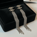 Silver CC logo chain fringe earrings on black velvet tray